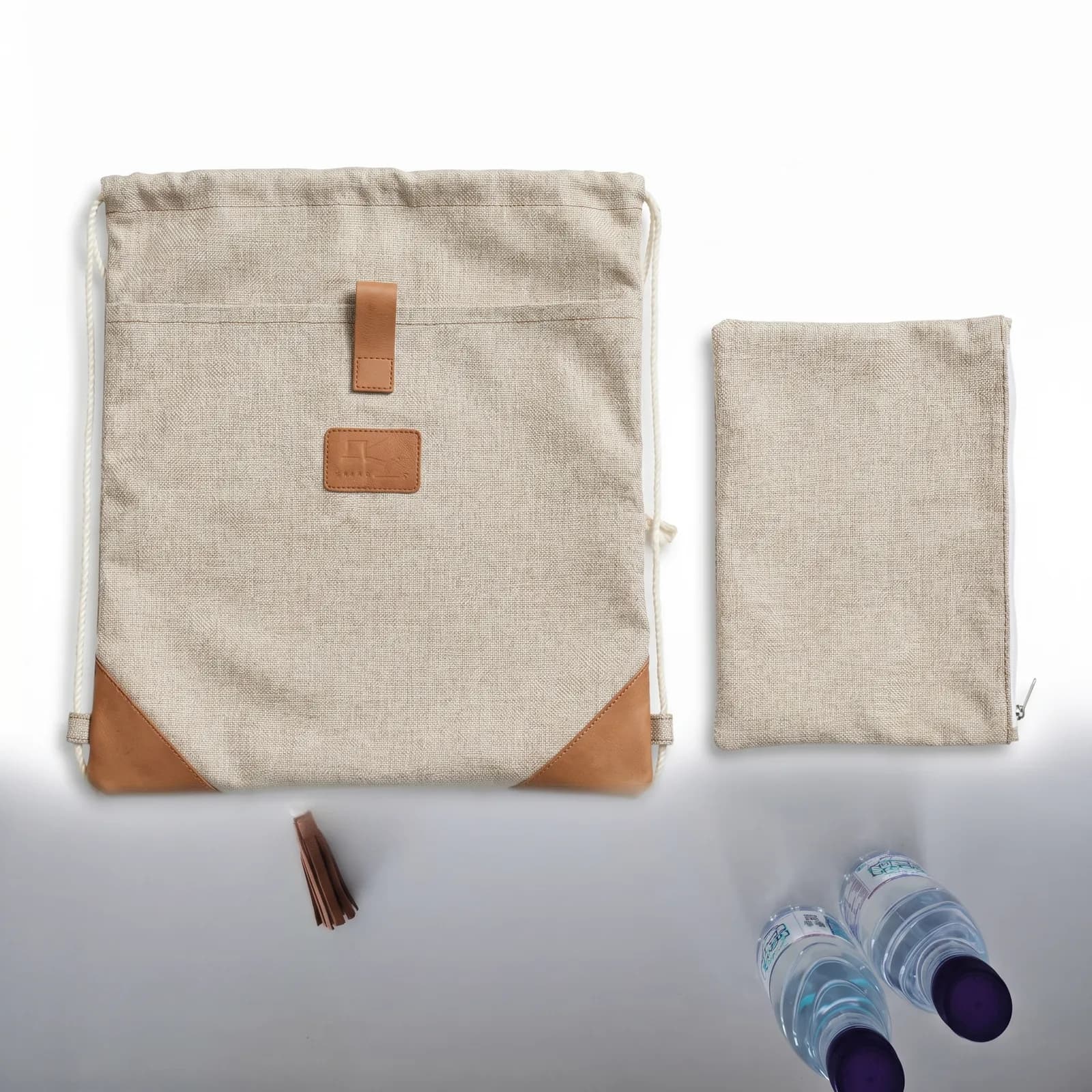 Canvas drawstring bag, pouch and mini bottles, branded and packed as one matched kit.